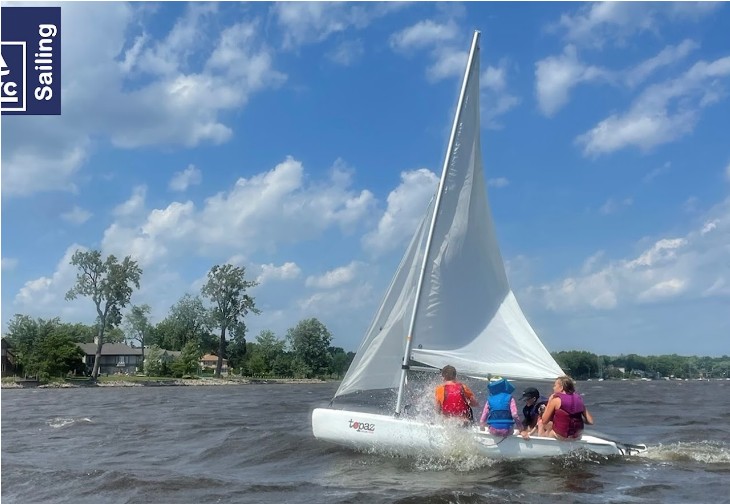 Family sailing a Topaz on Lake St-Louis